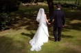 Deux mariés, l'épouse est en robe blanche, s'éloignent en se tenant la main